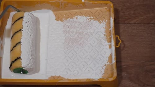 Close Up of Paint Roller Loading with Paint