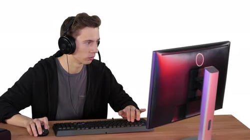 Young Adult Using Desktop Computer at Desk
