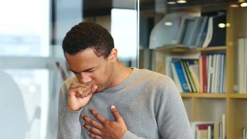 Young Man Coughing Indoors Close Up Shot