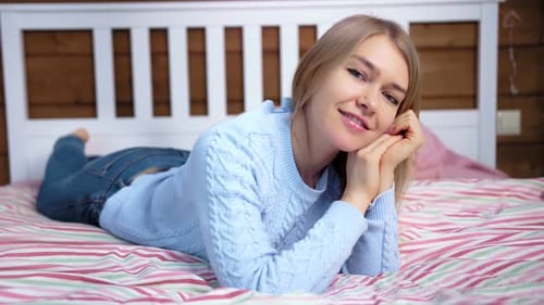 Smiling Woman Lying on Bed at Home