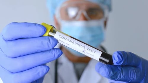 Doctor Holding Coronavirus Test Vial in Hospital