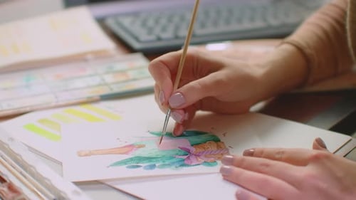 Young Adult Painting with Watercolor at Desk