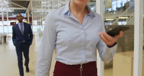 Professional Woman Talking on Cellphone in Modern Office