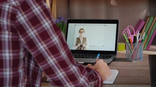 Student Attending Online Class and Taking Notes