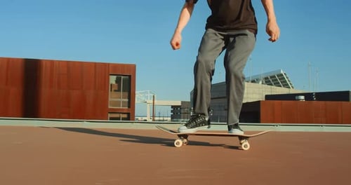 Young Adult Skateboarding on Rooftop in Urban Setting