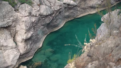 Deep Steep Canyon with Turquoise Water Stream and Rapids