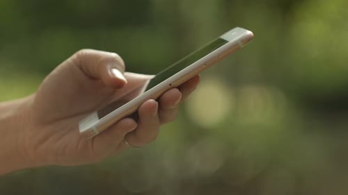 Hand Holding and Touching a Smartphone