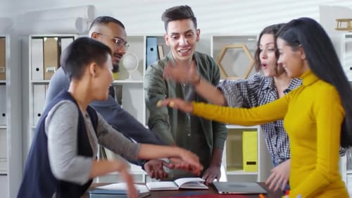 Energetic Team Celebrates Success in Modern Office