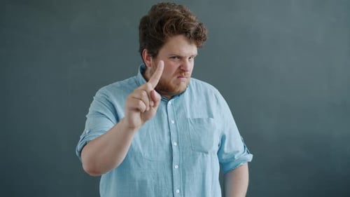 Man Wags Finger in Warning