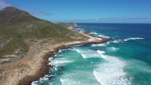 Flying Over Turquoise Ocean Waves at Rocky Seashore