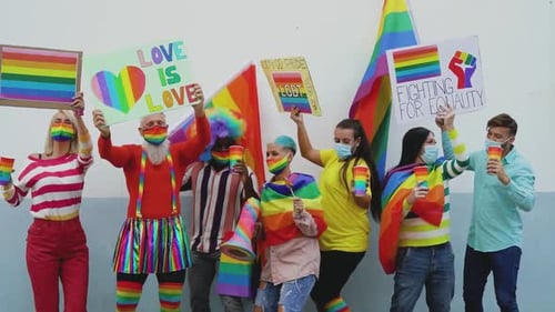 Diverse Group Holding Pride Signs and Rainbow Flags