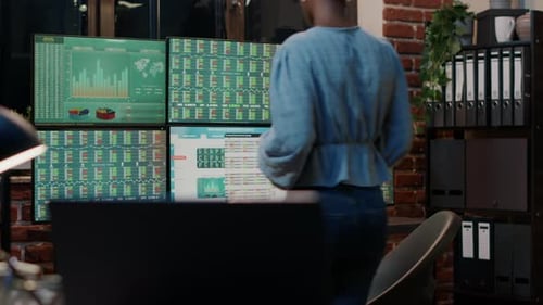 Woman Analyzing Stock Market Data at Her Desk