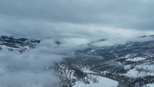 Clouds High in the Winter Mountains Aerial View 4 K