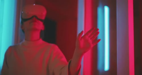 Woman Using Virtual Reality Headset with Neon Lighting