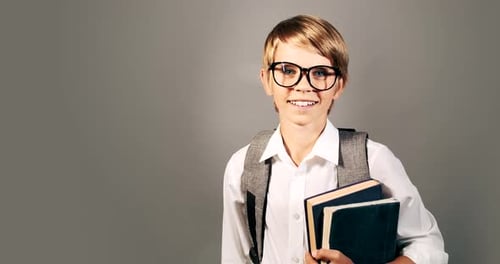 Smiling School Boy with Books and Backpack