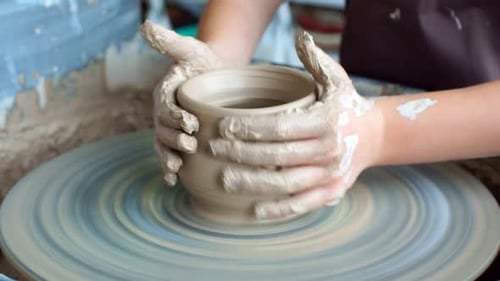 Pottery Class Workshop. Clay Shaping on Potter's Wheel. Potter Teaches His Craft To the Children