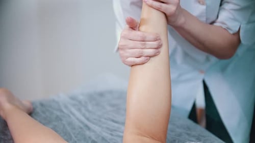 Woman Receiving Leg Massage at a Medical Facility