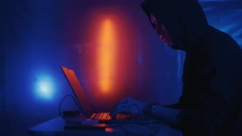 Hacker is Working on Laptop at Night