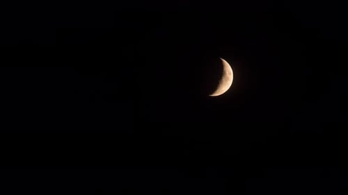 Waxing Crescent Moon Glowing in Dark Night Sky