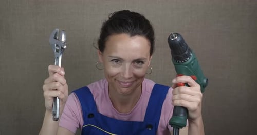 Drill and Tool in Woman Hand