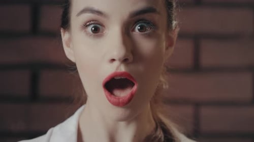 Close Up of Shocked Woman in Front of Brick