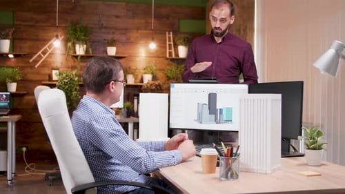 Team of Architects in the Office Talking About Design for the New City Skyscrapers