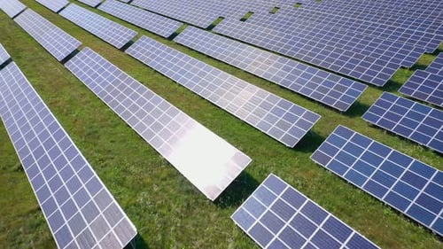 Flight Over a Field of Solar Panels in Sunny Summer Day