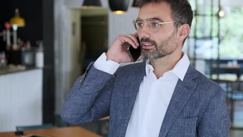 Businessman using smartphone in cafe