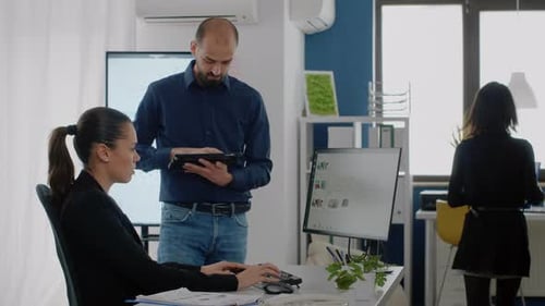 Adults working at computers in a modern office