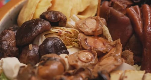 Sauce Pouring Over Delicious Asian Dish Close Up