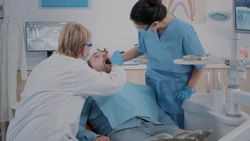 Dentist Examining Patient's Teeth in Modern Office
