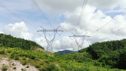 Electrical Transmission Towers on a Green Hillside