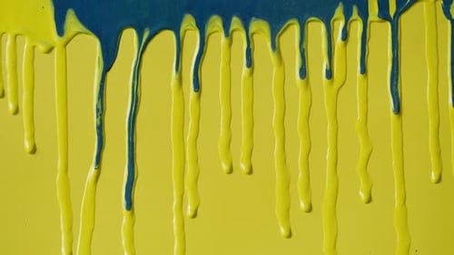 Blue Paint Dripping on Yellow Background