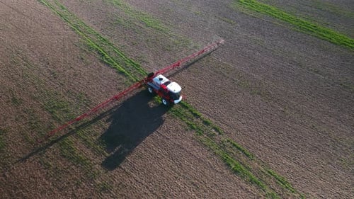 Tractor Spraying Fields on an Arable Farm with Glyphosate Herbicide