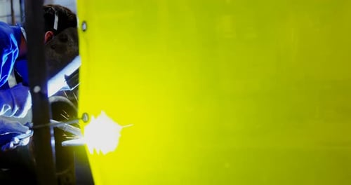 Male engineer using welding torch 4k