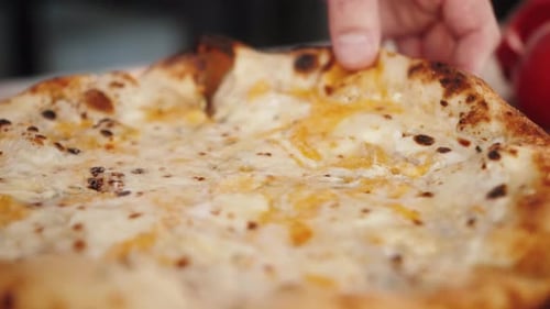 Close up of Cheesy Pizza Slice Being Lifted