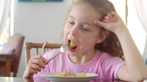 Happy Child Eating Healthy Organic and Vegan Food in Restaurant