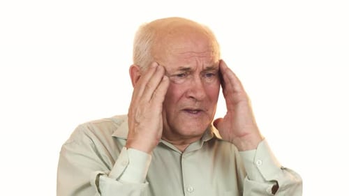 Senior Man Suffering from Headache Rubbing Temples