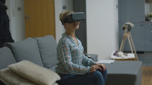 Woman Using Virtual Reality Headset on Couch