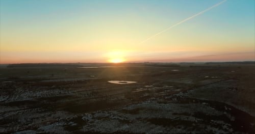 Golden Sunrise Over Frosty Rural Landscape