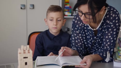 Teacher Explains to His Schoolboy the Homework that Was Done at the School