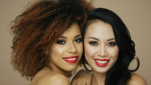 Two Young Women Posing With Makeup On