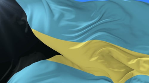 Realistic Waving Flag of The Bahamas Against Blue Sky
