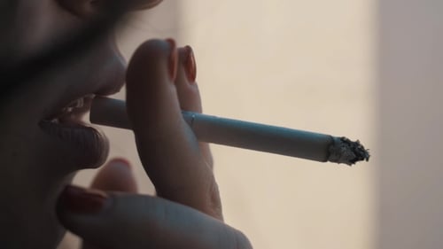 Woman Smoking a Cigarette in Close Up