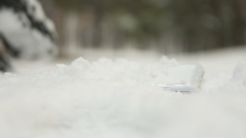 Phone Falls Out of Pocket and Falls Into Snow in Winter on Walk