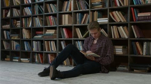 Pensive Student Reading a Book in Campus Library