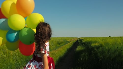 Little Girl in a Field with Balloons