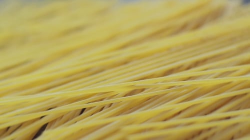 Uncooked Spaghetti Noodles on Wooden Surface Close-Up
