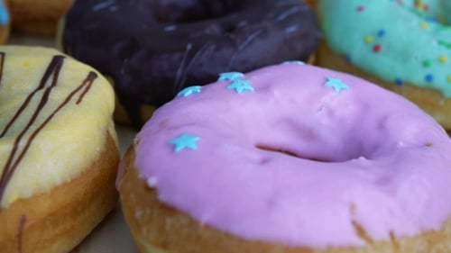 Delicious Glazed Donuts with Sprinkles Close Up