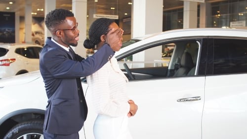Gift for Beloved of Woman, Man Standing Behind Woman Near New Auto, Surprise in Car Sales Center.